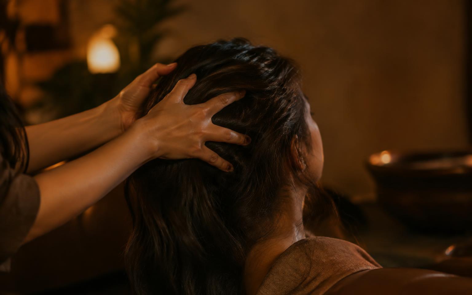 Therapist massaging a client's scalp